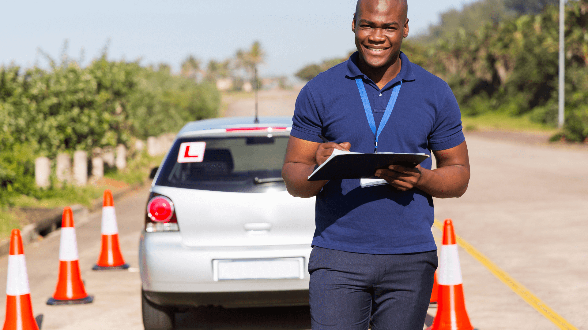 Driving instructor marking learner driver progress on test course