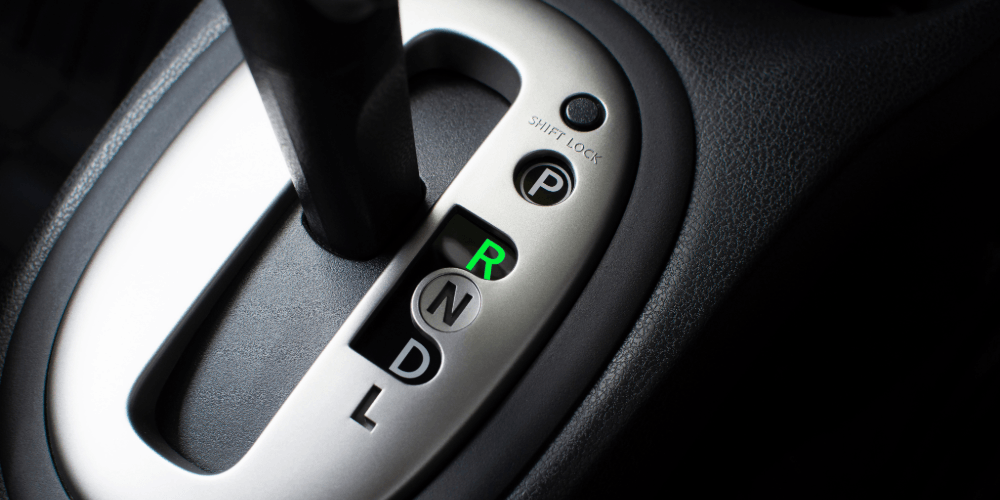 gear stick of an automatic car being used in an automatic driving lesson