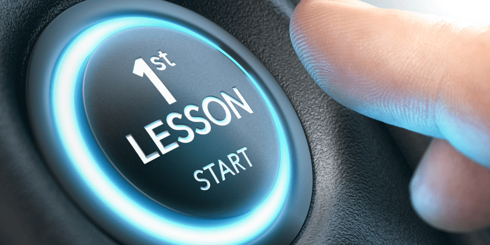 finger pushing a button launching 1st driving lesson